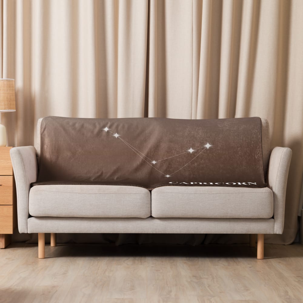 Capricorn Zodiac Blanket in Cocoa in a lifestyle setting