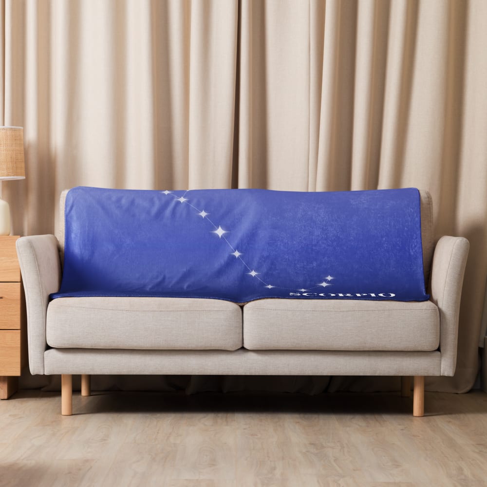 Scorpio Zodiac Blanket in Royal Blue in a lifestyle setting